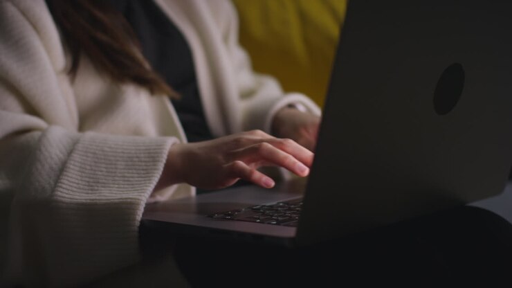 Close Up Of Woman Typing On Laptop Keyboard Spending Evening At Home Sitting On Sofa Browsing Online