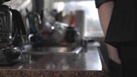 man's hands grabbing his wallet and keyless car remote at the kitchen top - closeup slowmo shot