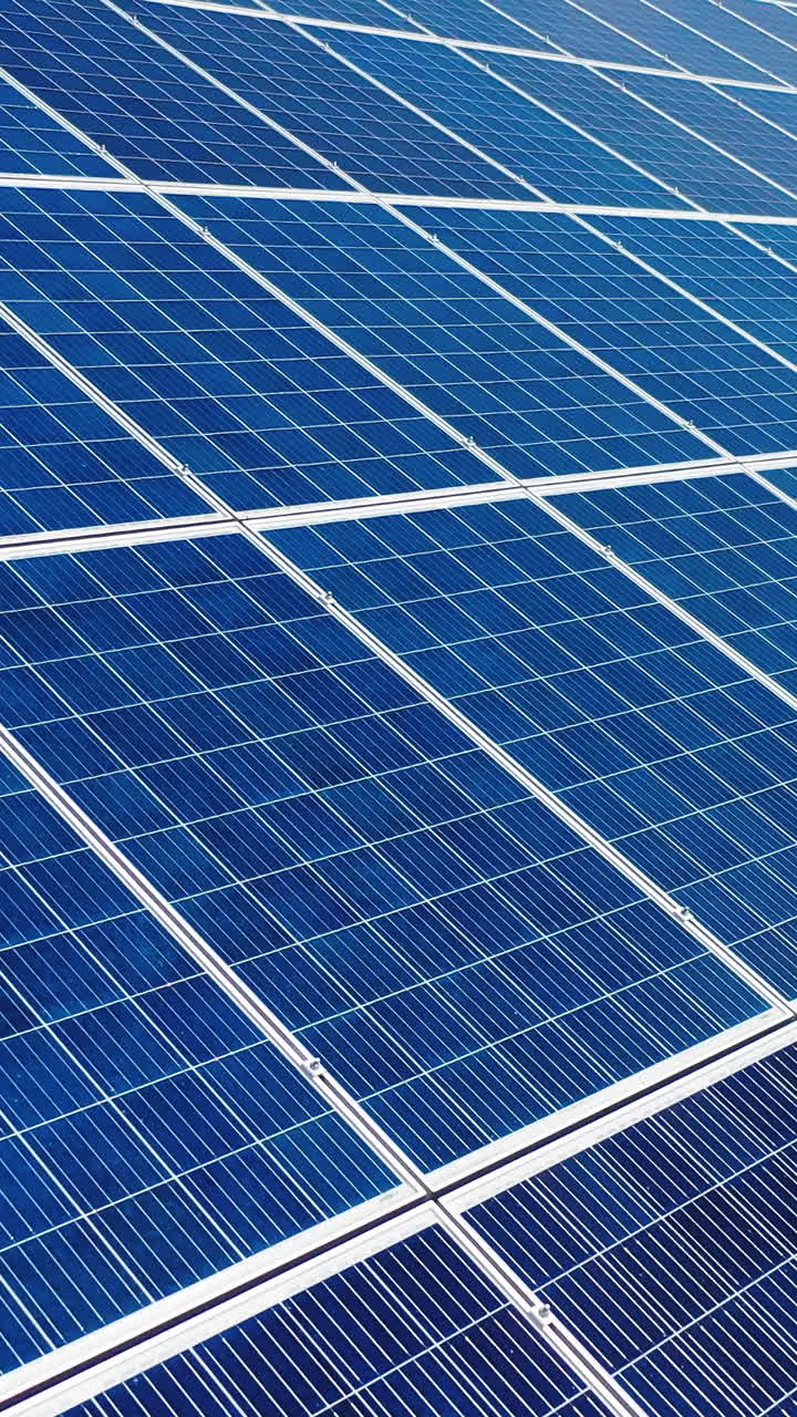 Solar power panel. Green energy. Electricity. Power energy panels. Solar batteries in field on sunny day. Aerial view. selective crop video focus. Vertical video