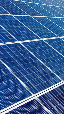 solar power panel. green energy. electricity. power energy panels. solar batteries in field on sunny day. aerial view. selective crop video focus. vertical video