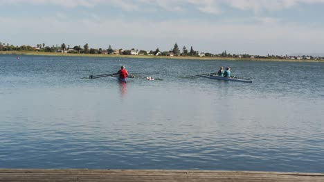 Four-senior-caucasian-men-and-women-rowing-boat-on-a-river