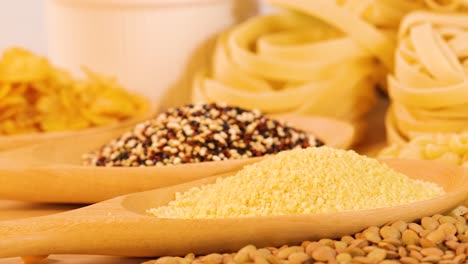 a colorful arrangement of grains, pasta, and bread slices under bright lighting, showcasing diverse textures and colors