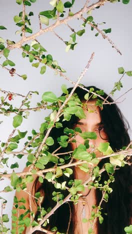 woman behind branches