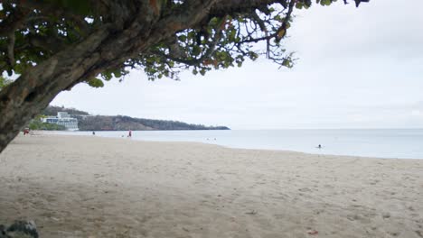 People-walking-on-Caribbean-beach-in-Grenada