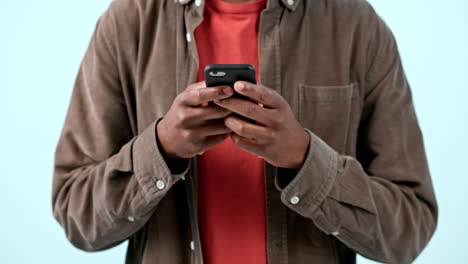 hands, phone and man typing in studio isolated