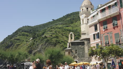 hillside medieval clock tower in the village of vernazza, cinque terre, liguria, italy, europe. tilt-down shot