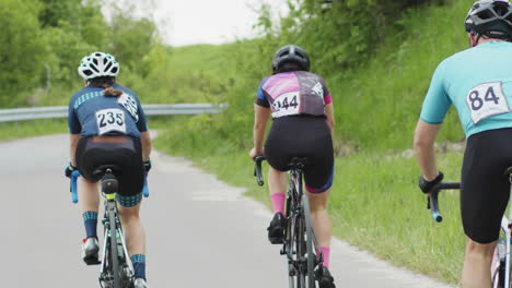 cycling marathon slow motion of a bicycle wheels tracking shot of a group of cyclists on country