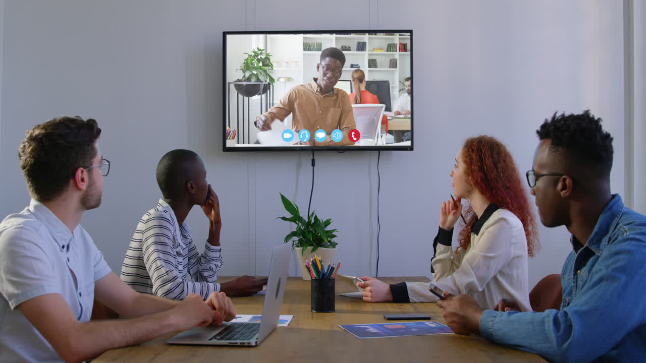 Creative business colleagues in video conference in meeting room in modern office