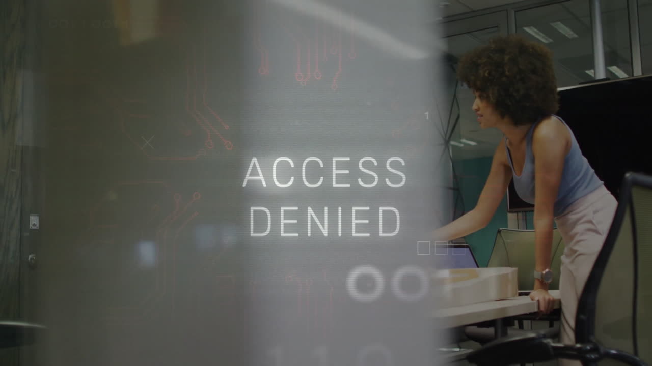 female analyst leaning over cubicle in technology office, showing binary overlay with ACCESS DENIED