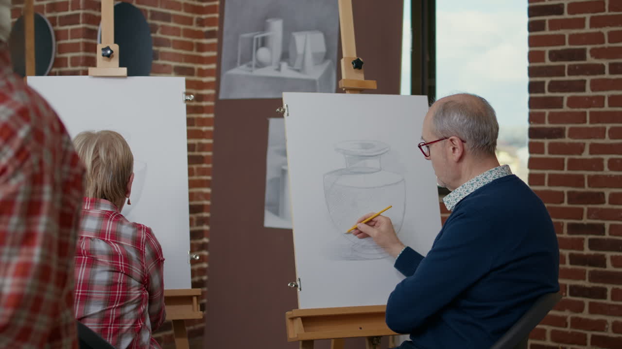 Elder man and woman drawing on canvas in art class