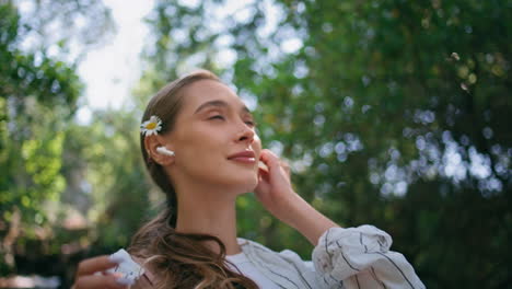 woman headphones walking nature at summer weekend close up. girl listening music