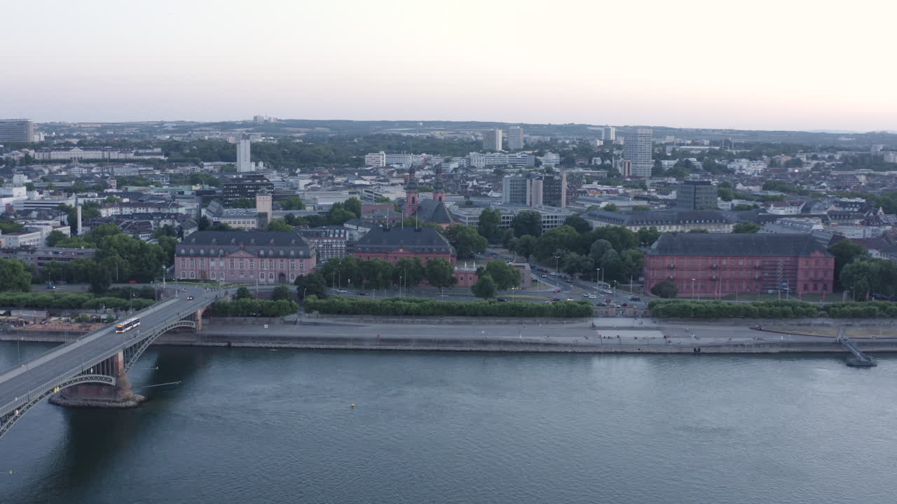 Aerial circling Drone View of Mainz Christuskirche Rhine River, Castle, dom, Theodor Heuss Bridge and Cityscape at Sunset Germany