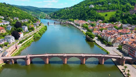 4k aerial drone video of the historic old bridge over the neckar river in heidelberg, germany