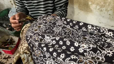 indonesian old women's hand making batik clothes