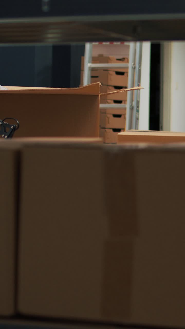 Vertical video: Empty storage space filled with stacks of merchandise and goods