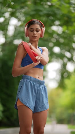 woman working out with resistance band in a park