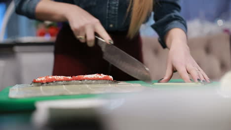 sushi roll process. closeup of chef hands preparing japanese food