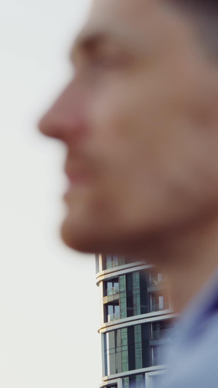 Man looking at a tall building