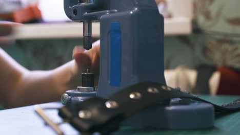 tailor changes metal nozzles in special press machine close