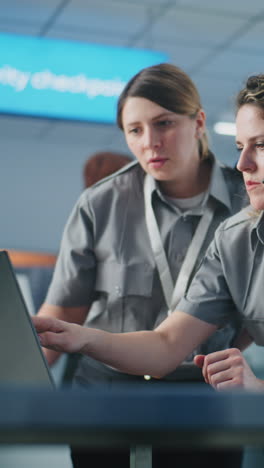 Airport Security Officers Working on Computer