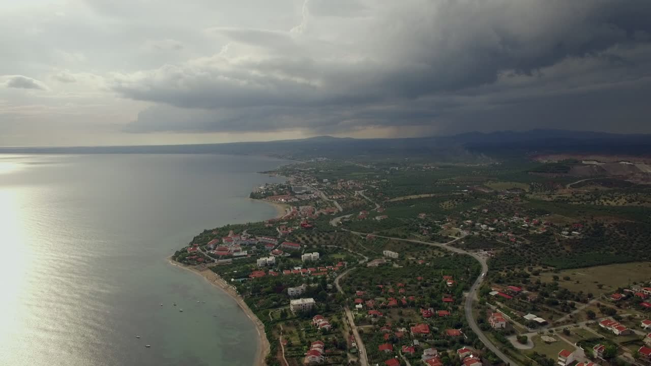 volando sobre la ciudad en vista de la costa con cielo nublado grecia