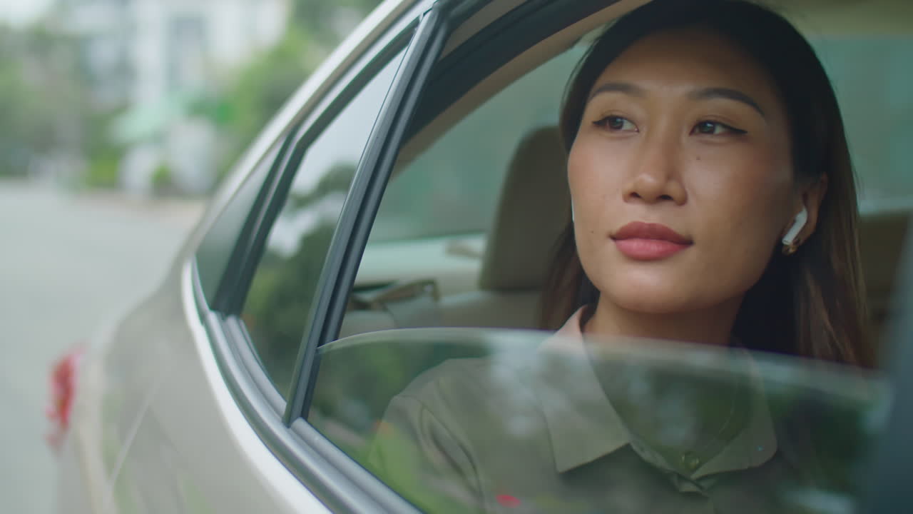 Asian Woman Riding in Taxi