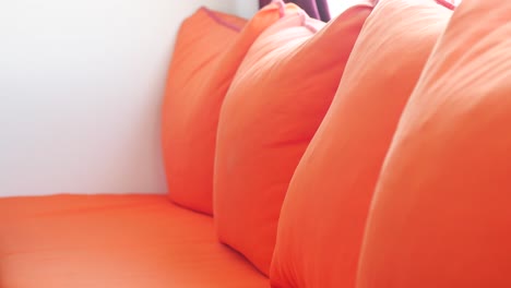 orange pillows on a bed