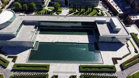 aerial view of modern building with courtyard and pool