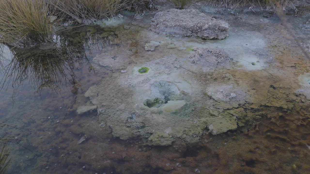 Hot mineral sulfur water with green sediment the boiling bubble from the hole on earth nature wonderful natural mineral water treatment spa n Iran Saudi Arabia wellness tourism Tabas Lut desert Neom