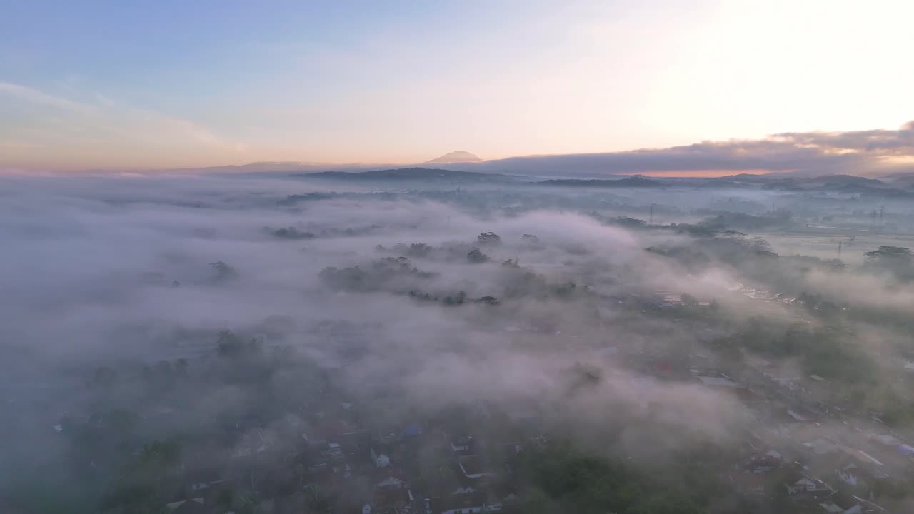 A misty sunrise in the countryside of Indonesia