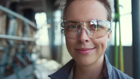 portrait dairy worker posing at milk farm production facility in glasses alone