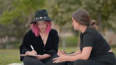 two women in conversation in a park