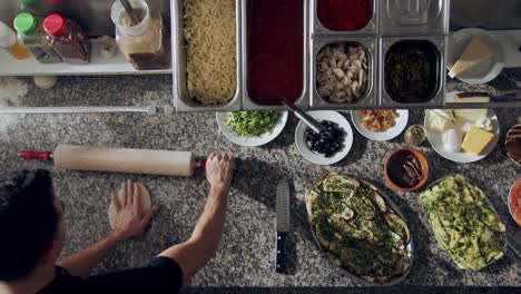 anonymous chef rolling dough for pastry