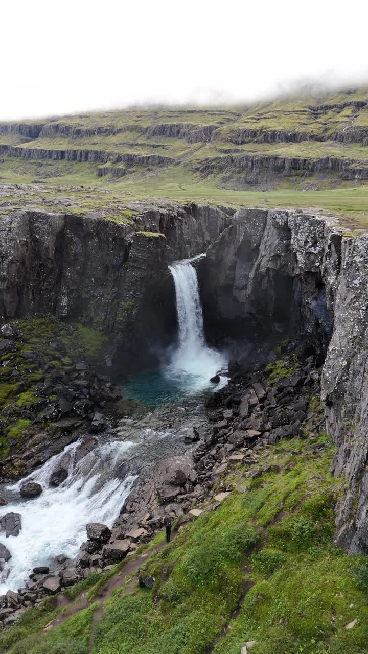 Dramatic pullback revealing the stunning Folaldafoss Waterfall in Iceland.