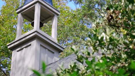 beautiful shot of church bell through the trees