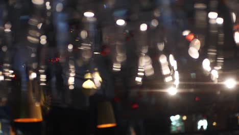 wine glasses hanging in a bar at night