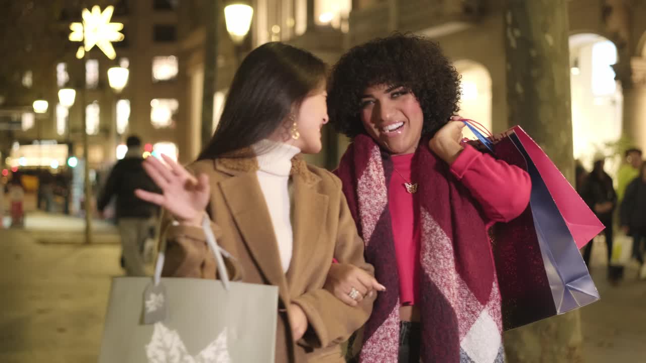 Two women shopping at night