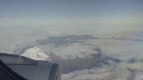 Aerial-view-from-plane,-propeller,-clouds-and-mountains