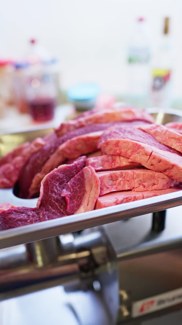 Fresh Raw Beef Slices on a Tray Ready for Grinding