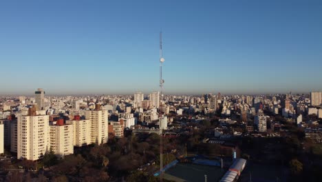 aerial - large antenna radio tower in buenos aires, argentina, wide circle shot