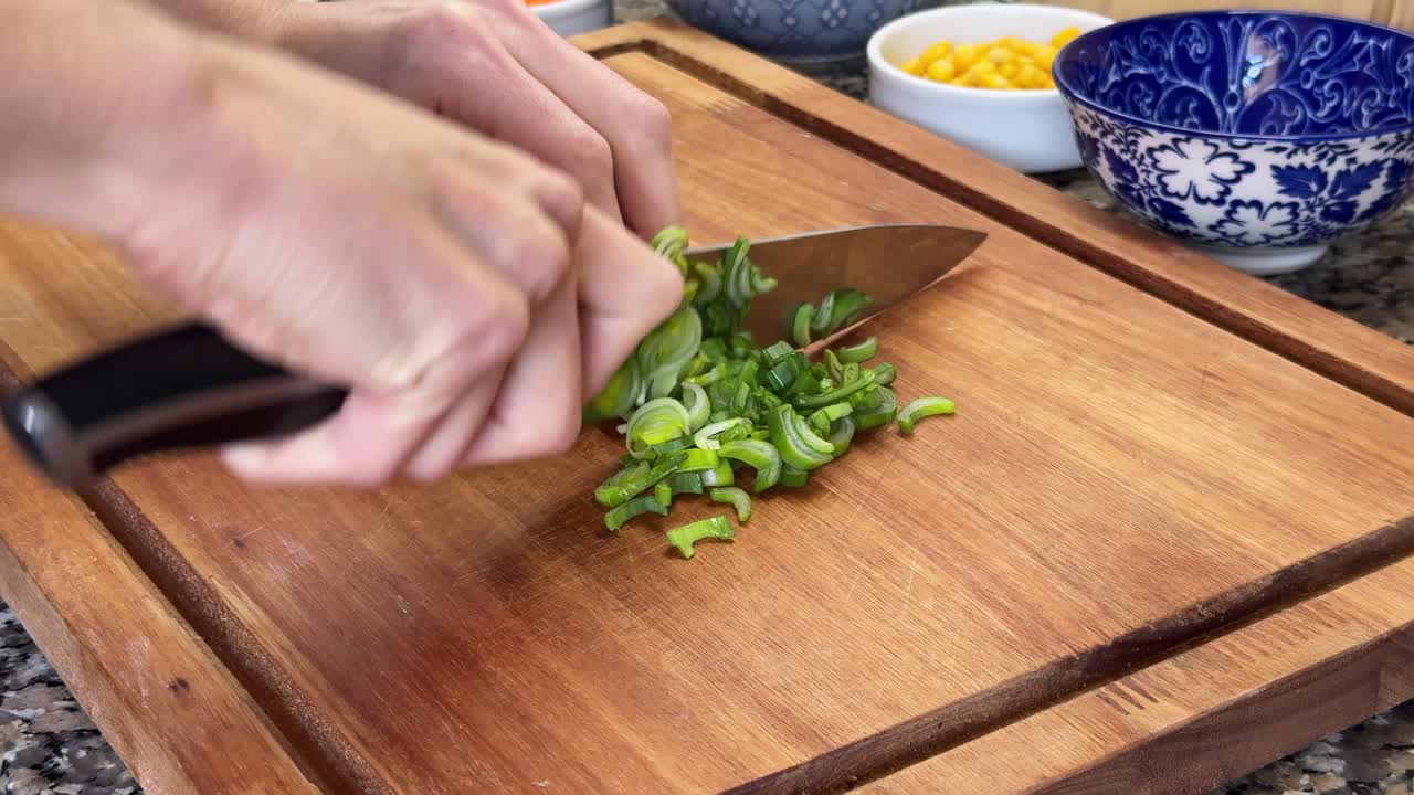 Person Chopping Green Onion (Scallion) Stalks. Close-up Shot