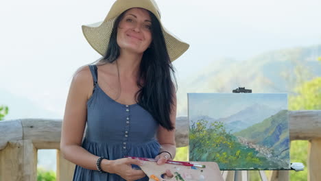 woman painting a landscape outdoors