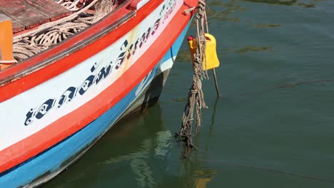 a stationary boat gently rocking on calm water