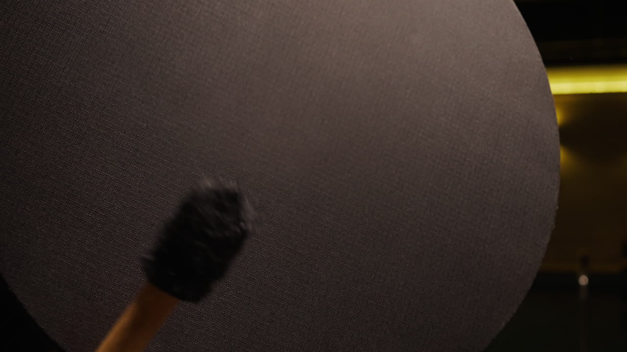 Close-up of a large black circular object with a textured surface