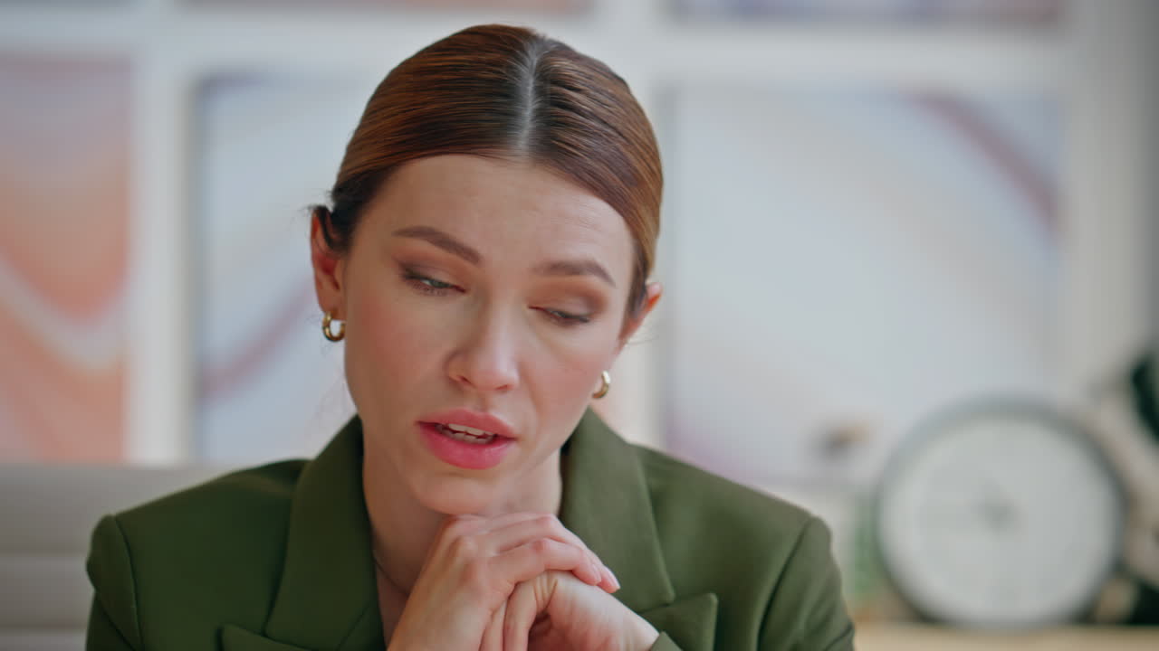 Closeup angry boss speaking web conference in office. Lady manager nodding head