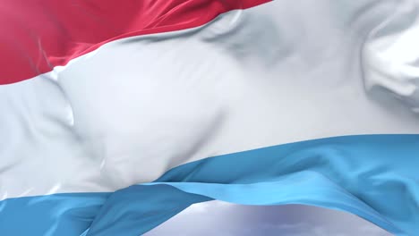 luxembourg flag waving at wind with blue sky in slow, loop