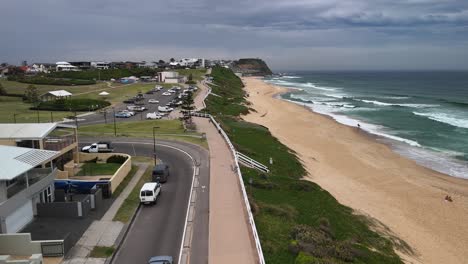 Low flyover of public waterfront promenade at Mereweather Beach, NSW