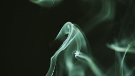 Video-of-green-clouds-of-smoke-moving-with-copy-space-on-black-background