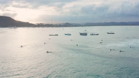 surfing at sunset at the surf spot don don in gerupuk, lombok