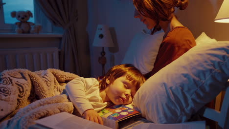 mother reading story to child in bed